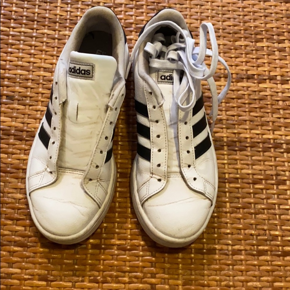 White adidas with black stripes